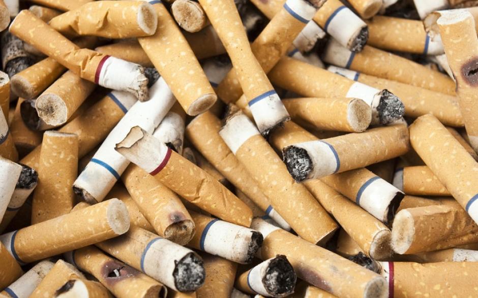 a close-up of a pile of used cigarettes